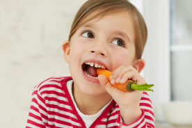 Child eating carrot